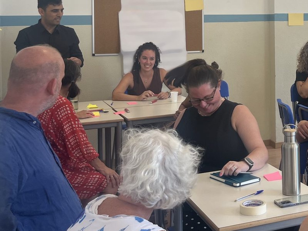 Teaching staff at Andersen International School, Milan, working together in small groups during on-site work