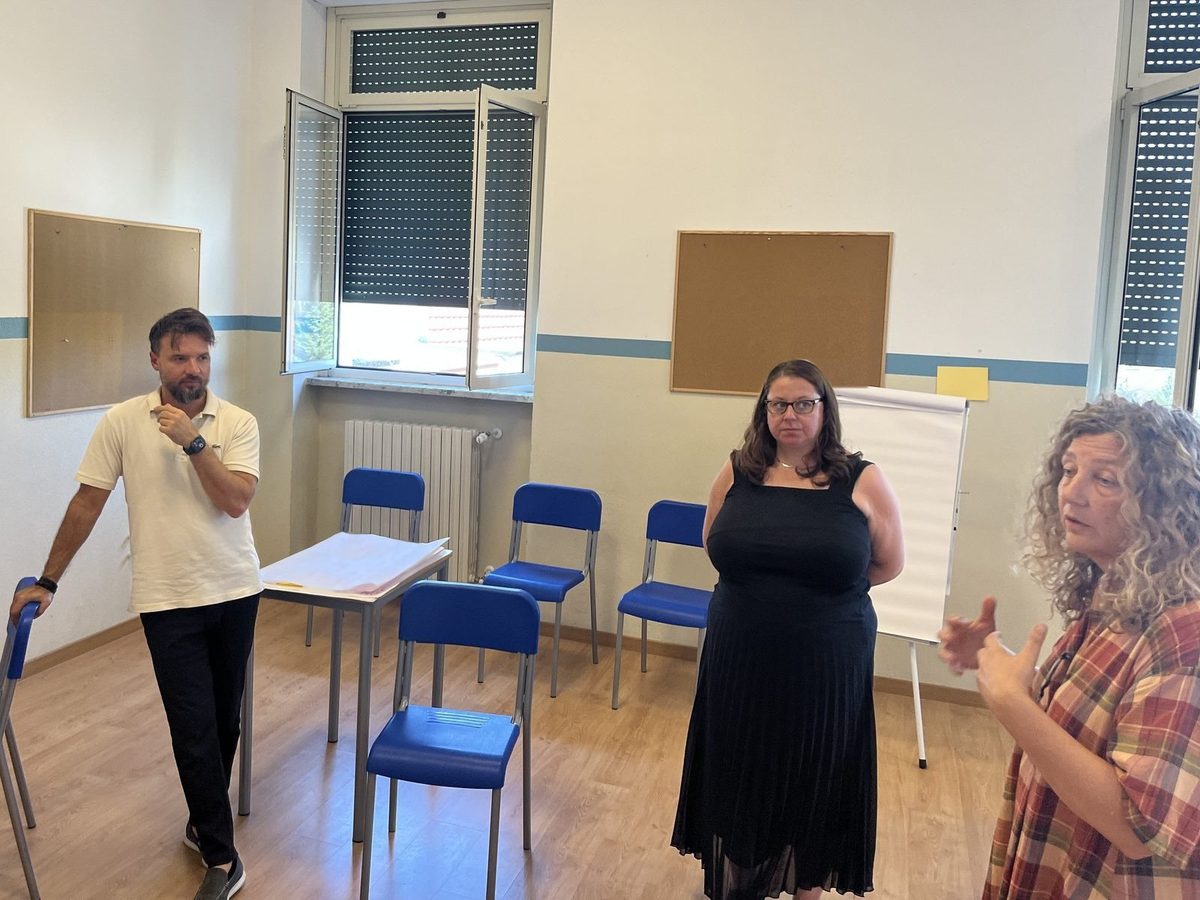 Three staff at Andersen International School, Milan, talking an idea through in a bright room
